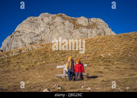 Montenegro. Mom and son tourists in the background of Durmitor National Park. Saddle Pass. Alpine meadows. Mountain landscape. Travel around Stock Photo