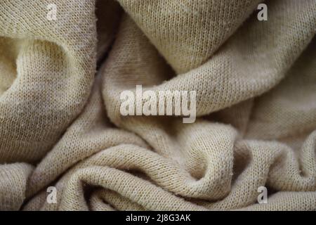 Knitted creamy background, beige sweater cozy pattern. Stock Photo