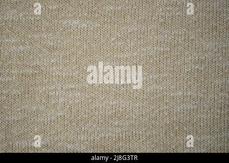 Beige sweater cozy pattern, knitted creamy background. Stock Photo
