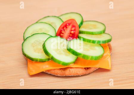 Crispy Cracker Sandwich with Fresh Cucumber, Tomato Cherry and Cheese on Cutting Board. Easy Breakfast. Diet Food. Quick and Healthy Sandwiches. Crispbread with Tasty Filling. Healthy Dietary Snack Stock Photo