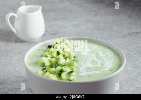 Cucumber Gazpacho. Green fresh cold summer soup on gray background Stock Photo