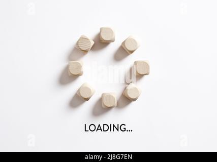 Wooden cubes with the word loading in loading progress indicator bar. Stock Photo