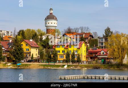 Elk, Poland - May 1, 2022: Panoramic view of Elk town center with historic water tower Wieza Cisnien at Jezioro Elckie lake shore in Masuria region Stock Photo