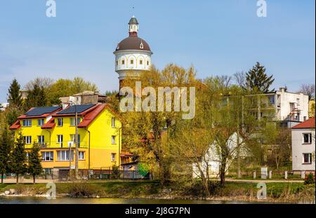 Elk, Poland - May 1, 2022: Panoramic view of Elk town center with historic water tower Wieza Cisnien at Jezioro Elckie lake shore in Masuria region Stock Photo