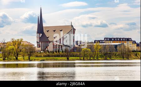 Elk, Poland - May 1, 2022: Panoramic view of Elk town with St. Rafal Kalinowski church of Salesians order on shore of Jezioro Elckie lake Stock Photo