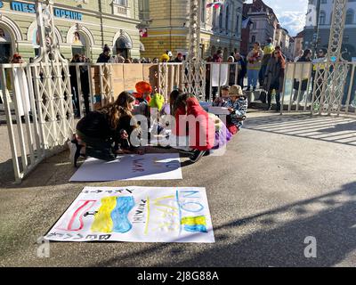 War in Ukraine. Children draw posters in support of Ukraine. People gathered in the city center to protest against Russia's invasion of Ukraine Stock Photo