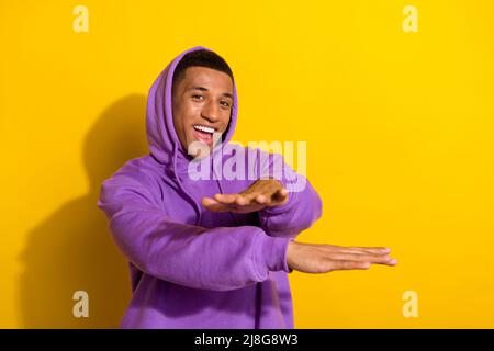 Photo of good mood millennial man have fun spend free time in nightclub dancing isolated on yellow color background Stock Photo
