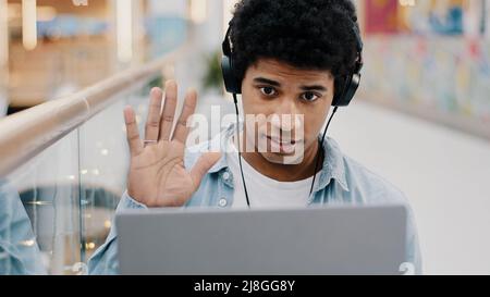 Portrait african american business man guy student male online coach teacher mentor consultant helpline worker call manager freelancer in headphones Stock Photo