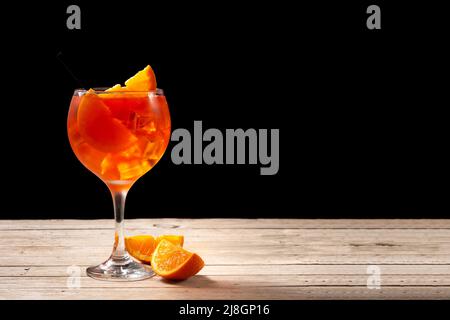 Glass of aperol spritz cocktail on wooden table Stock Photo