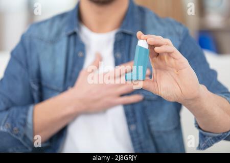 asthma inhaler in a male hands Stock Photo