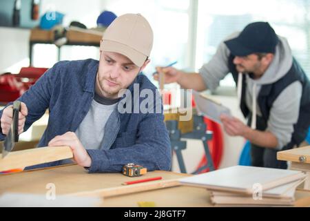 two wood designer working in workshop Stock Photo
