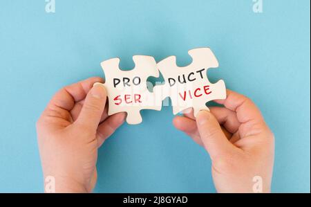 The words product service are standing on two puzzle pieces, customer satisfaction and support, business strategy Stock Photo