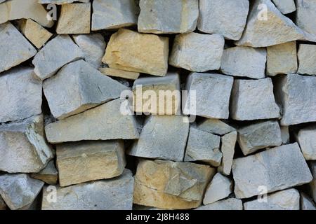 Wall made of pieces of limestone Stock Photo