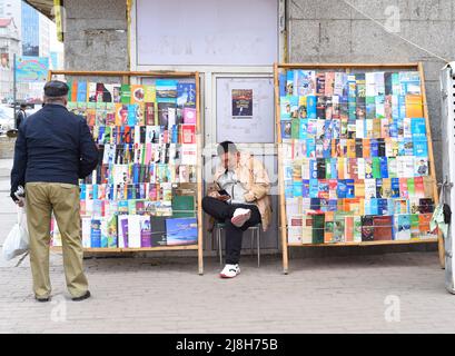 Ulaan Baatar, Mongolia - 05.13.2022: mongolian man sells many books in different languages  on the street Stock Photo