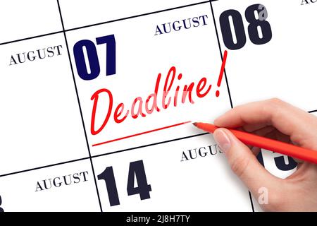 7th day of August. Hand drawing red line and writing the text Deadline on calendar date August 7. Deadline word written on calendar Summer month, day Stock Photo