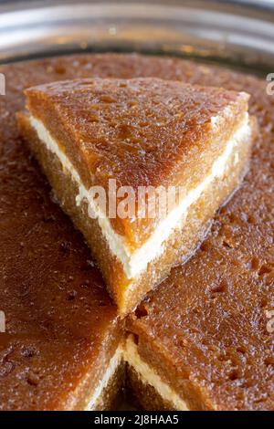 Bread kadayif on a white background. Sliced bread kadayif in a tray. local name ekmek kadayif Stock Photo