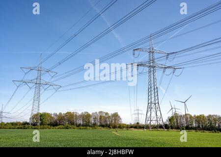 Electricity pylons and power lines seen in Germany Stock Photo