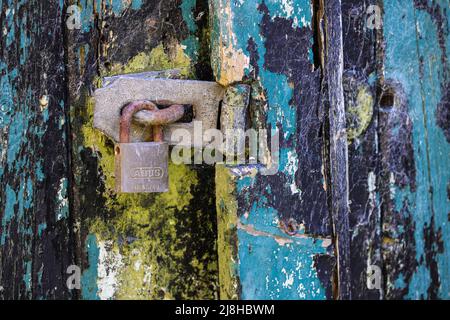 Old padlocked door latch Stock Photo