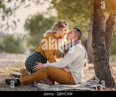 Man and woman tourists in the mountains at sunset. Happy couple in love Stock Photo