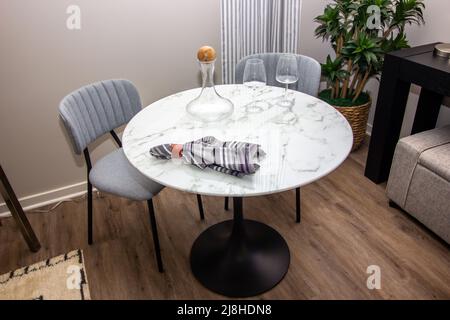 Small Round Granite Table With Two Chairs Stock Photo