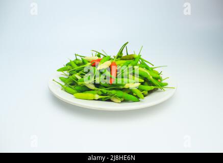 Peppers. Pile of fresh green and red bird's eye chili peppers isolated on white background Stock Photo