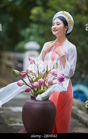 Ho Chi Minh city, Viet Nam: Vietnamese girl going to pagoda in ao dai Stock Photo