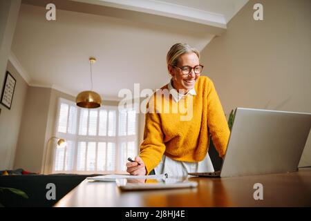 Caucasian female business woman working from home Stock Photo