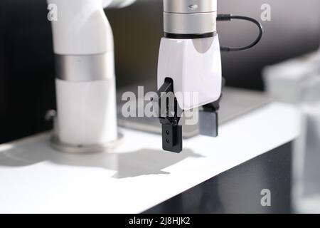 Mechanical white arm robotic arm in production Stock Photo