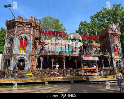 BERLIN, GERMANY - MAY 10, 2022: Ghost Train Ride HAUNTED CASTLE on the funfair, country fair Maientage. Spooky puppets, animatronics, giant skull crea Stock Photo