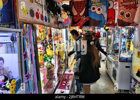 KYOTO, JAPAN - NOVEMBER 27, 2016: People play claw machines with Pokemon toys at a game arcade in Kyoto, Japan. Claw machines in Asia are also known a Stock Photo