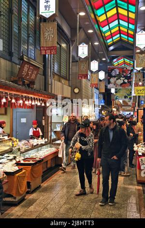 KYOTO, JAPAN - NOVEMBER 27, 2016: People visit Nishiki Market in Kyoto, Japan. Nishiki is a popular traditional food market place in Kyoto. Stock Photo