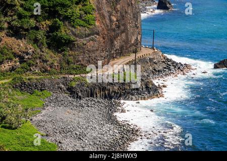 Aerial view of a narrow passage on Hana Highway in the southeast of Maui island, Hawaii - Winding coastal dirt road along a wild coast of the Pacific Stock Photo