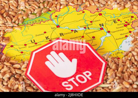 Wheat grains on the map of Ukraine with a stop signal, Ukrainian grain crisis, global hunger crisis concept due to war Stock Photo