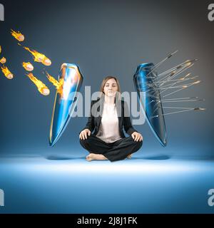 woman in meditation who protects herself with shields from dangers Stock Photo