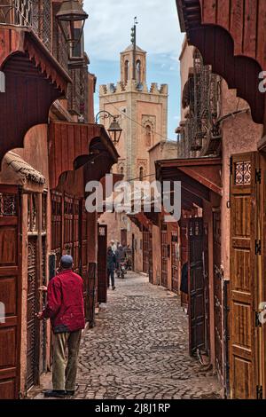 MARRAKECH, MOROCCO - FEBRUARY 20, 2022: People visit streets of medina (Old Town) of Marrakech city, Morocco. The historic medina quarter is a UNESCO Stock Photo