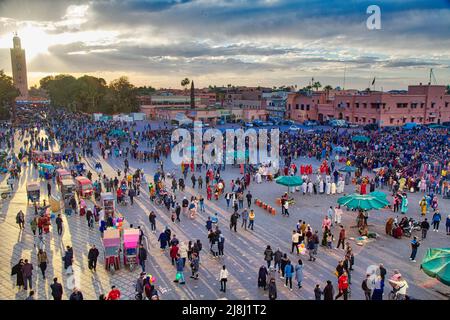 MARRAKECH, MOROCCO - FEBRUARY 20, 2022: People visit Jemaa el-Fnaa square market of Marrakech city, Morocco. The square is listed as UNESCO Masterpiec Stock Photo