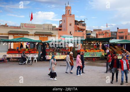 MARRAKECH, MOROCCO - FEBRUARY 20, 2022: People visit Jamaa el-Fnaa square market of Marrakech city, Morocco. The square is listed as UNESCO Masterpiec Stock Photo