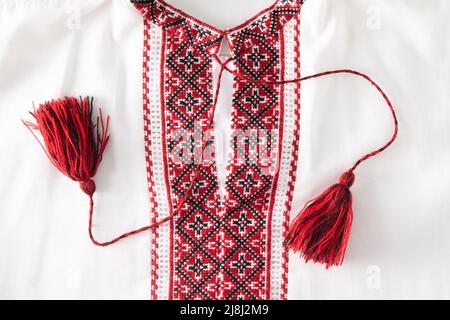 National Ukrainian embroidery. Handmade. Cross stitch in red, black and white. Traditional shirt of Ukraine. Embroider background. Stock Photo
