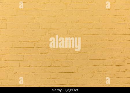 pattern of harmonic painted yellow brick wall as background Stock Photo