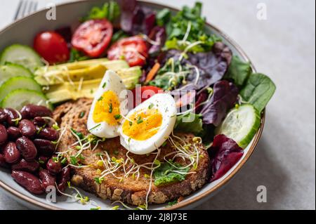 Medium boiled eggs with sasld, healthy breakfast Stock Photo