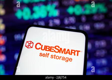 In this photo illustration the CubeSmart logo seen displayed on a ...