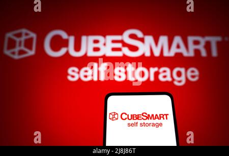 In this photo illustration the CubeSmart logo seen displayed on a ...