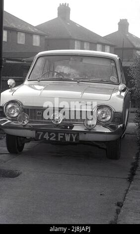 1969, historical, front view of a Ford Consul Corsair car parked in a suburban street, London, England, UK. The model seen here is a 2-door Consul Corsair 1500, produced between 1963 and 1965. A larger engine version of the same car, the V4 was produced from 1965 to 1970. Right-handed Corsairs were a rare car, as most of the 2-doors were LHD exported to Europe. Stock Photo