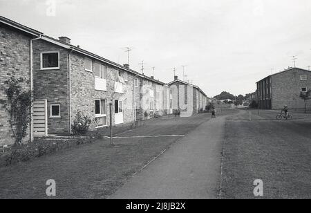 1970s, historical, exterior view of a new suburban housing estate, showing the plain architecture style of the era and surrounding layout, with central path running through the estate, England, UK. Stock Photo