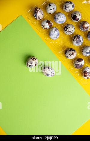 Three quail Easter eggs lying on two beige pastel shades with a hard shadow. Trendy isometric beige background. Stock Photo