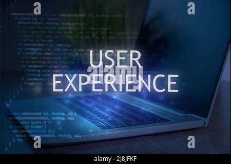 User experience inscription against laptop and code background. Technology concept. Stock Photo