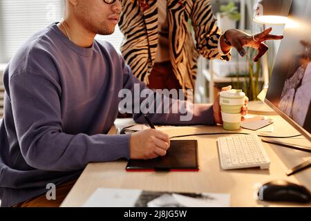 Closeup of male photo retoucher using pen tablet while editing pictures, copy space Stock Photo