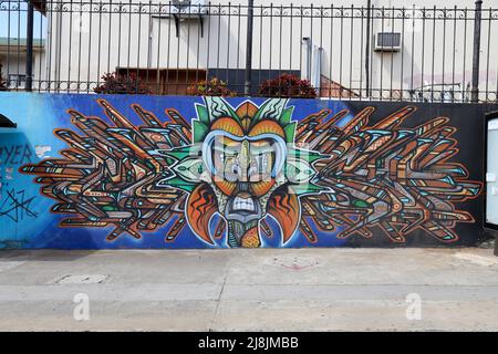 Costa Rica street art - Graffiti artwork, showing a tribal mask surrounded by boomerangs. Unknown artist Stock Photo