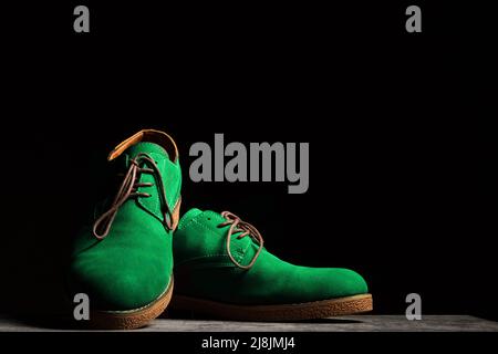 Concert green shoes with laces on a black background with copy space Stock Photo