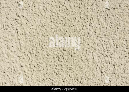 Rough uneven, texture beige concrete a wall Stock Photo